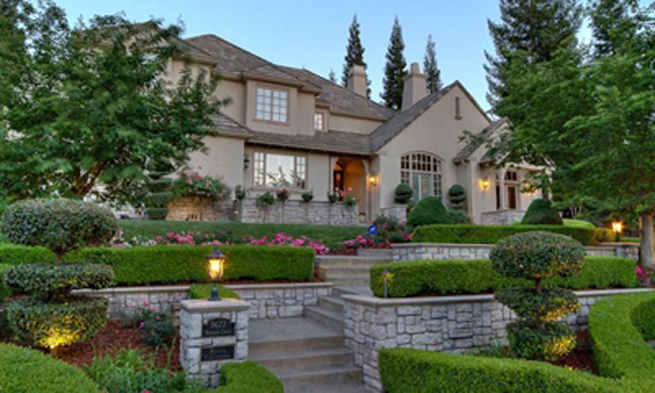 Wexford Design Build Custom Home French Country style custom design-build home slate roof and stucco exterior and stone pathways and garden walls