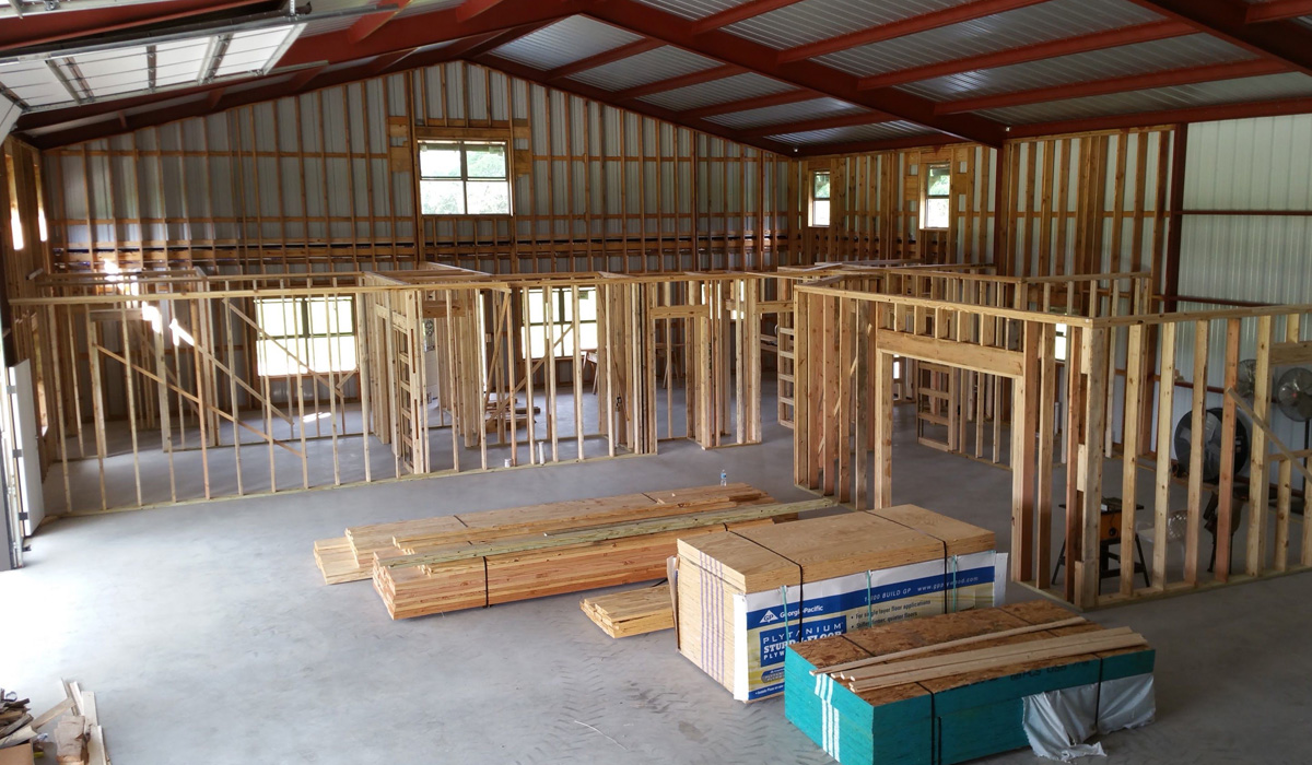 Interior view of steel framing and steel trusses for barndominium
